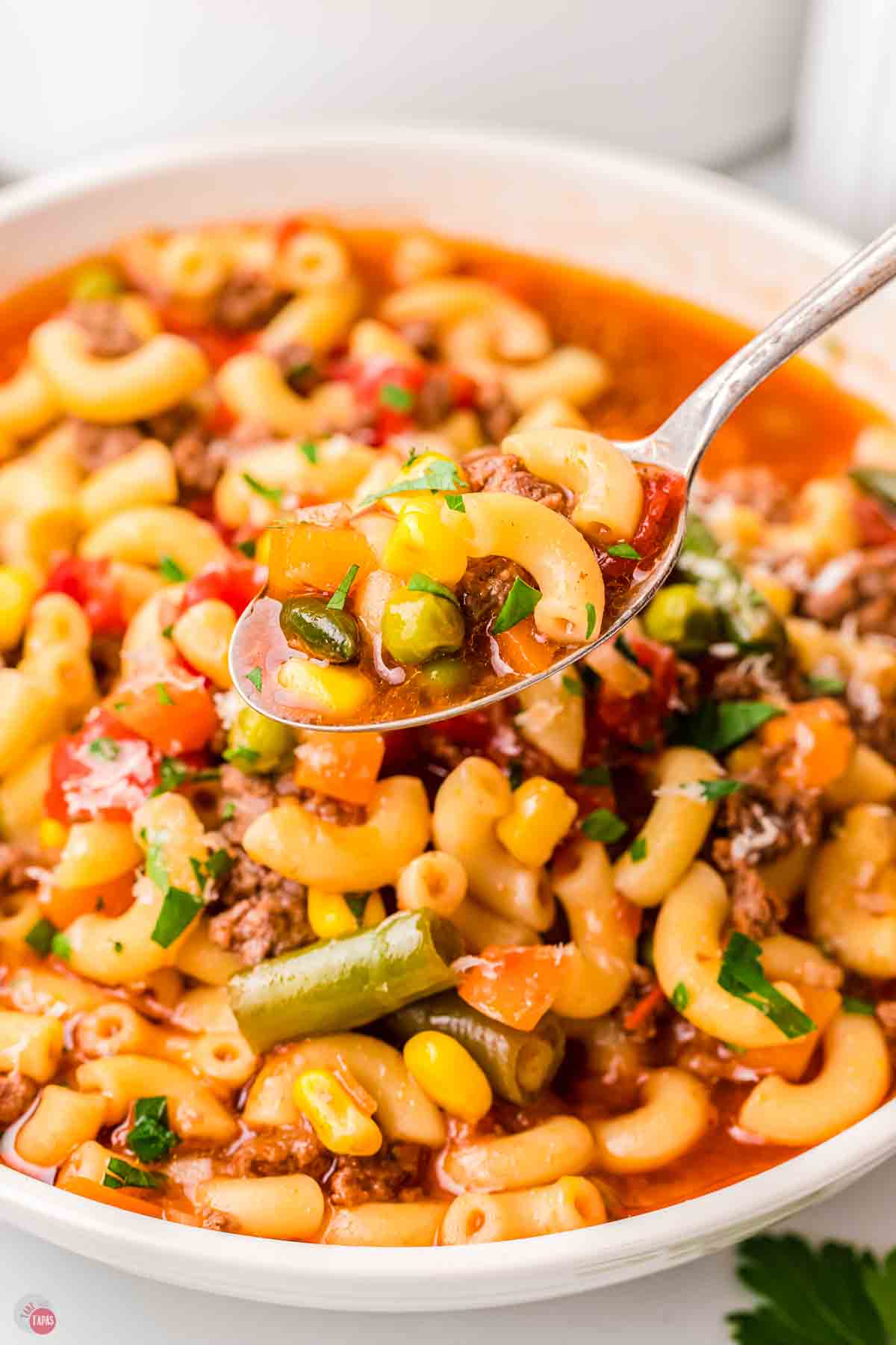 close up of pot of soup with a spoon in it