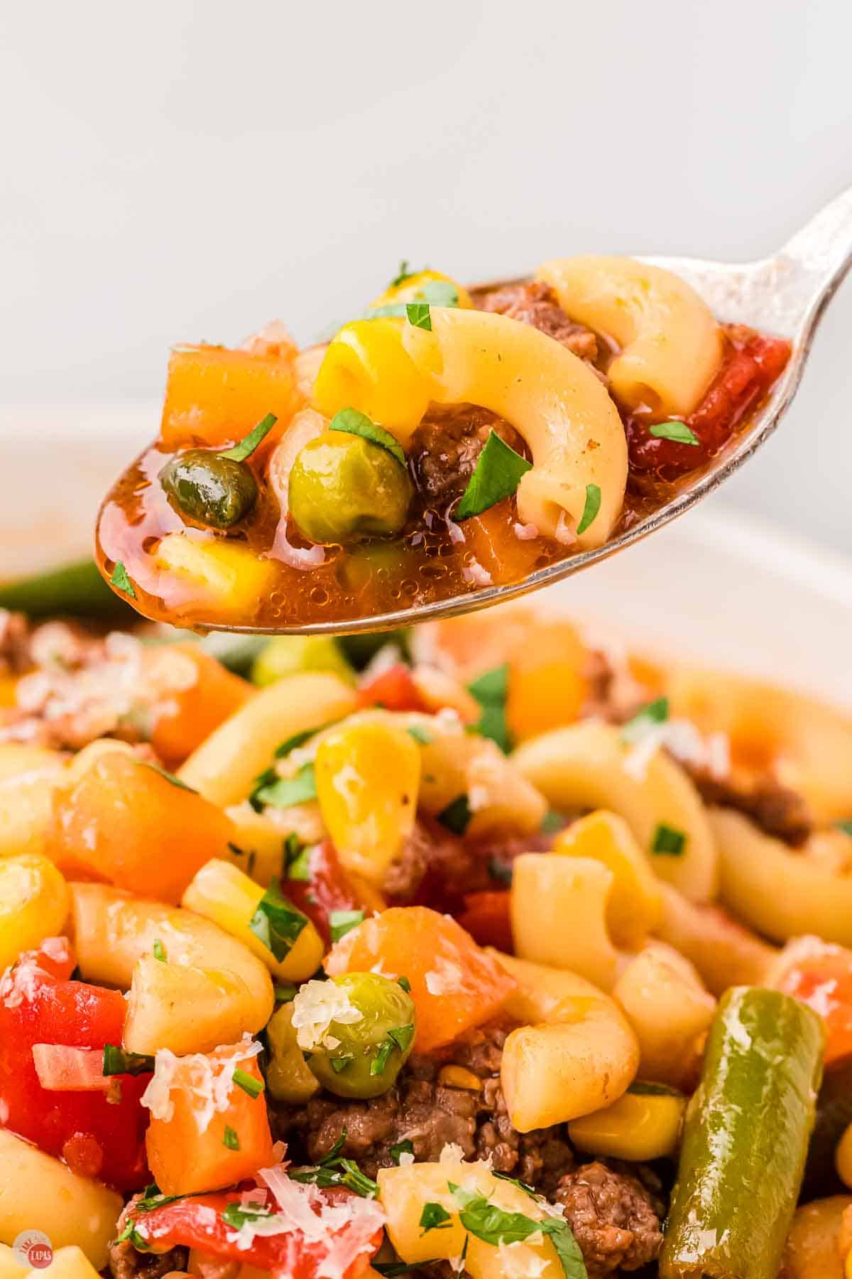 close up of spoon filled with soup