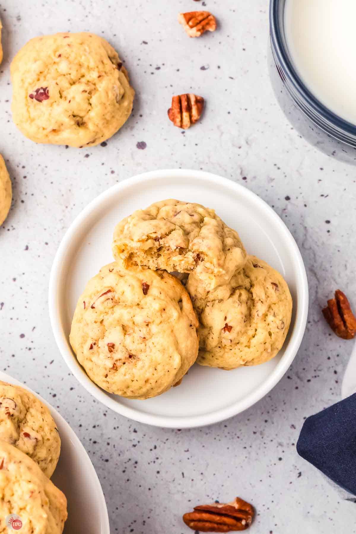 plate with three cookies and on with a bite missing