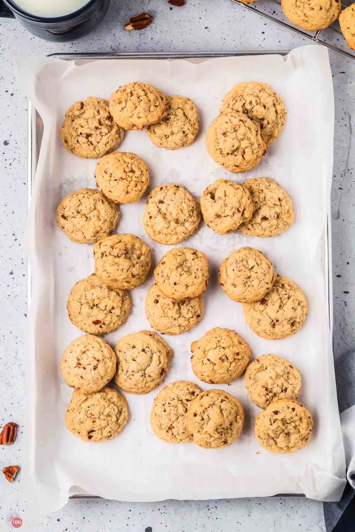 baking sheet with parchment paper covered in butter pecan cookies