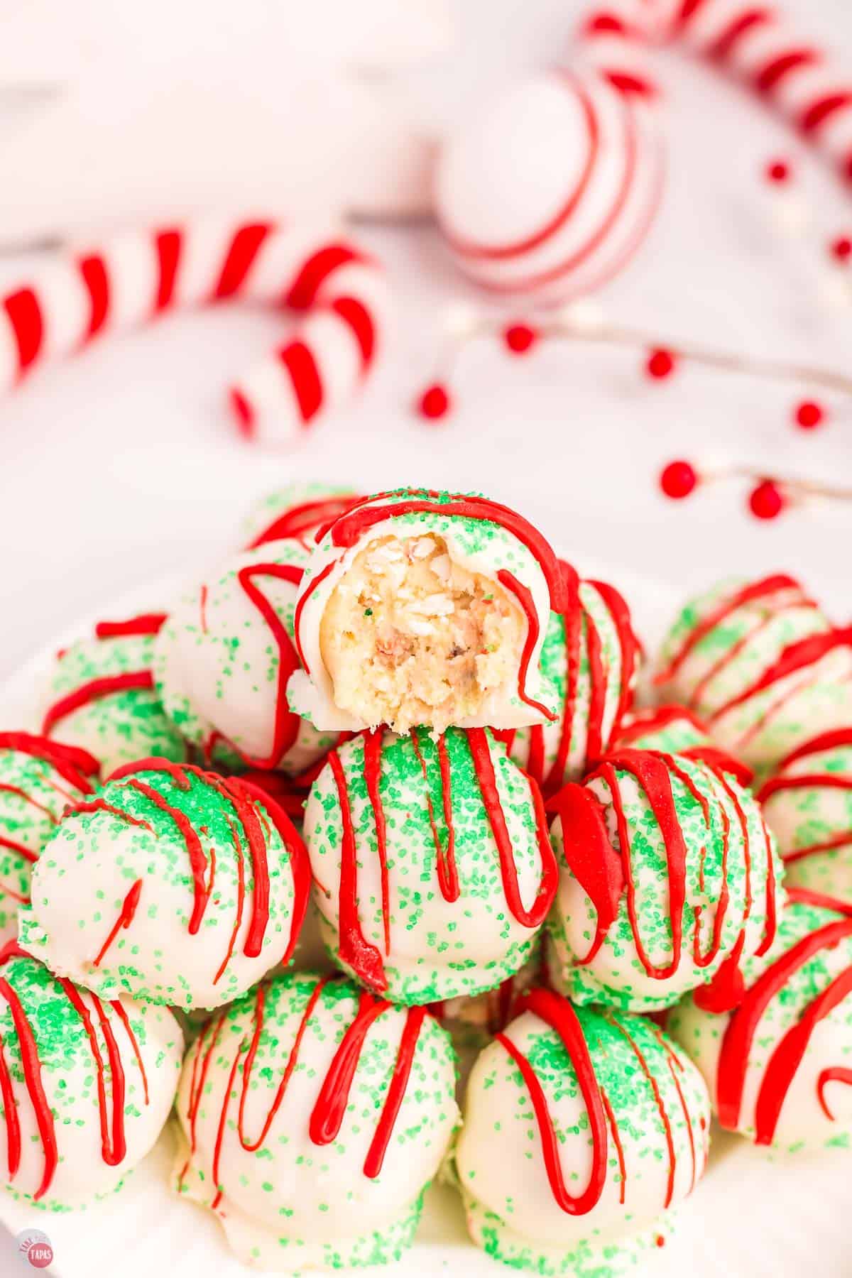 stack of Christmas tree cake balls with the top one missing a bite