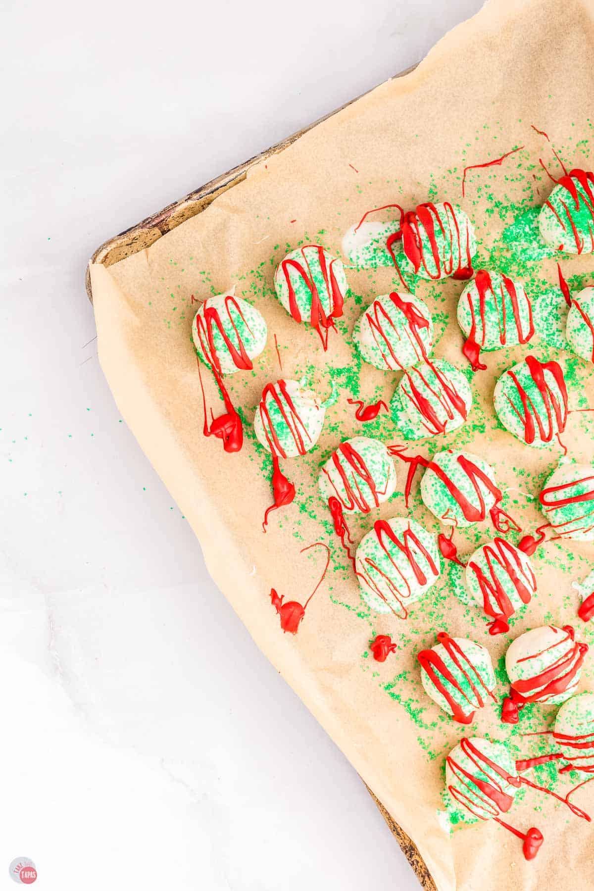 Christmas tree cake balls on a baking sheet with parchment paper