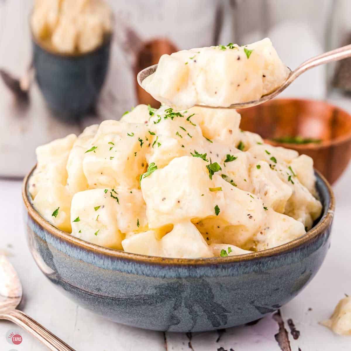 bowl of creamed potatoes with a spoon