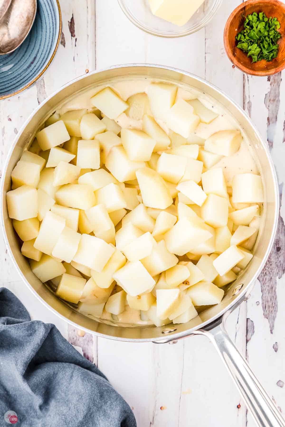 silver pot filled with diced potatoes