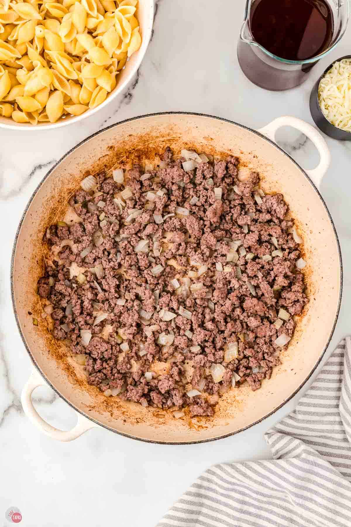 ground beef cooking a white pot