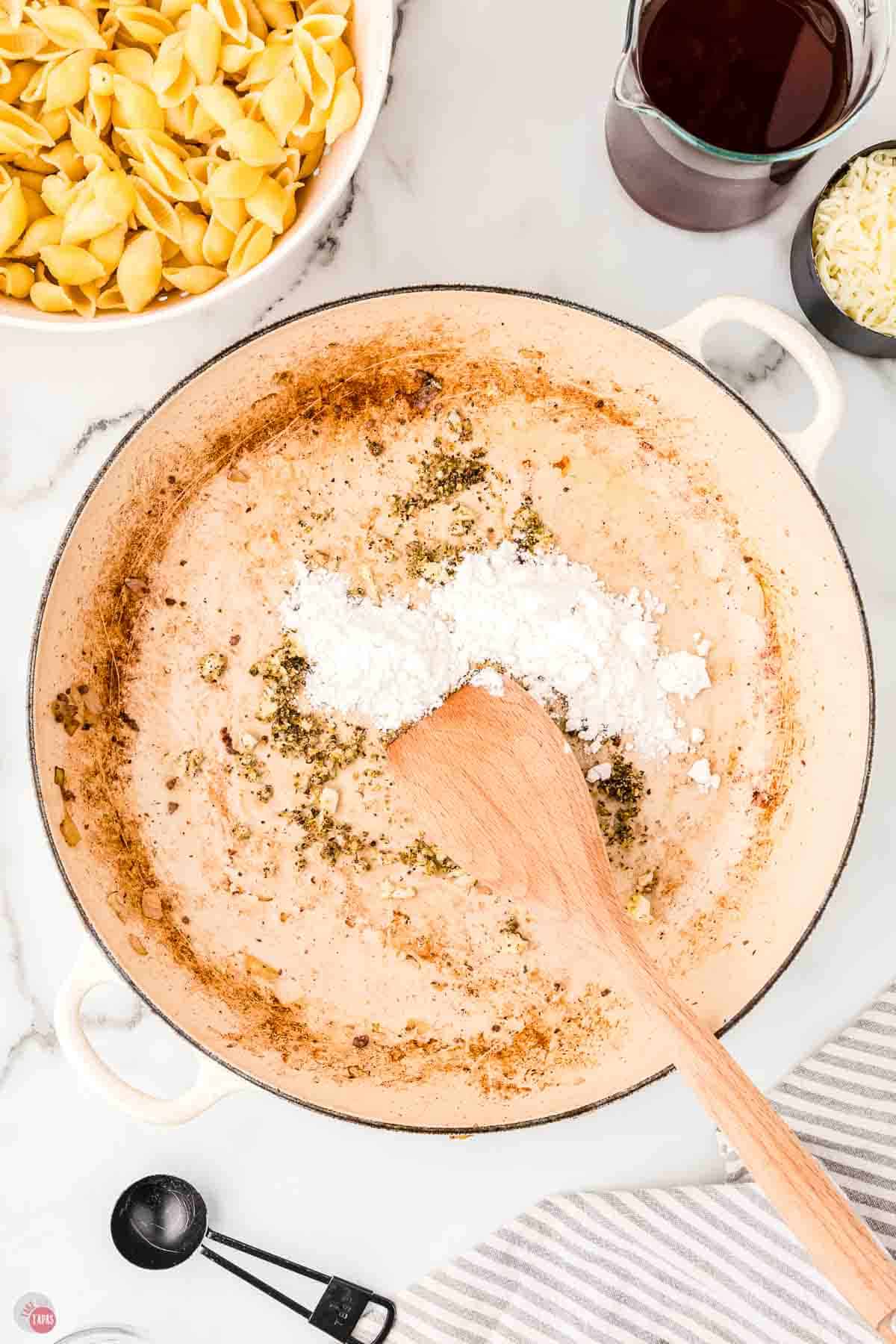 wood spoon stirring flour and spices in a pot