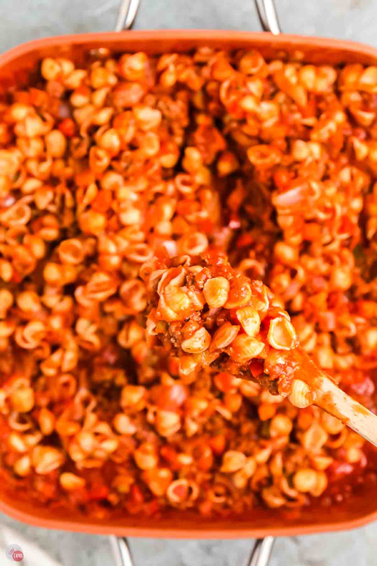 close up of beefaroni in a wood spoon