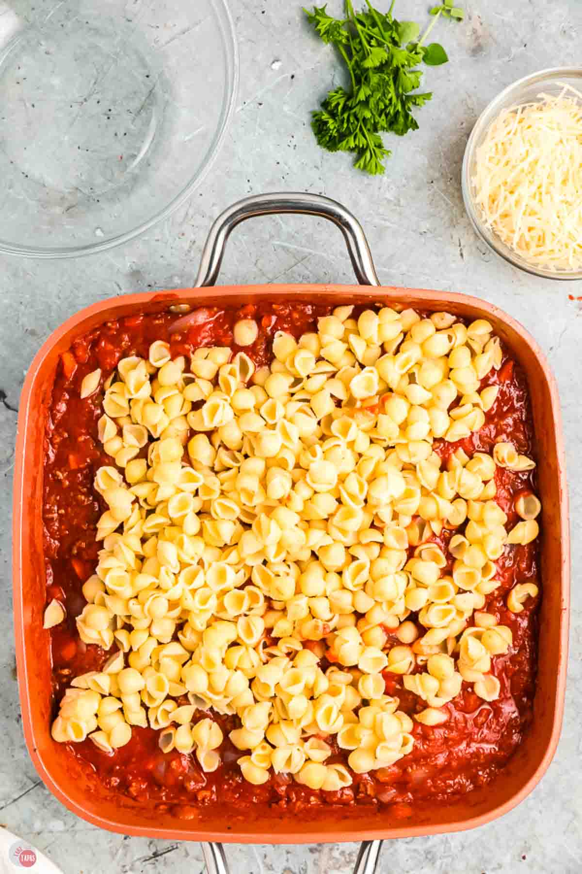 cooked pasta noodles on top of sauce in a skillet