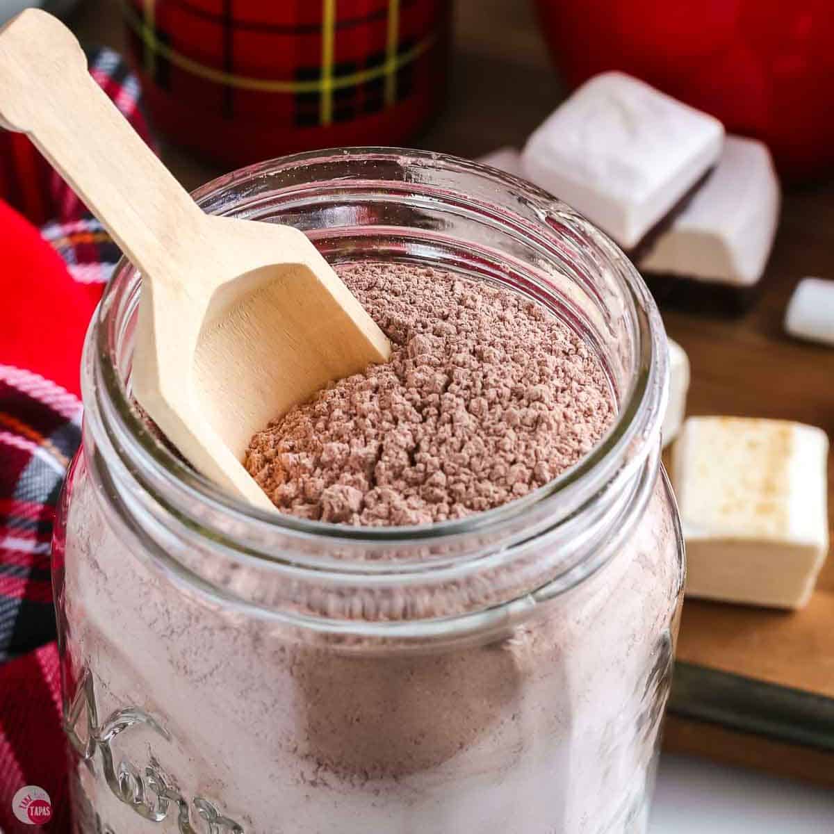 jar of cocoa powder with a small wood scoop
