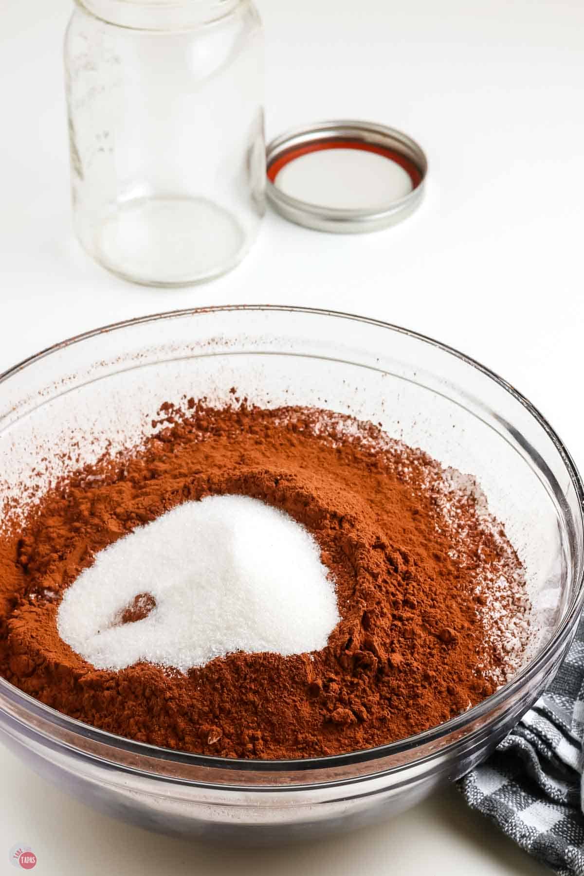 clear bowl with cocoa powder and sugar in it