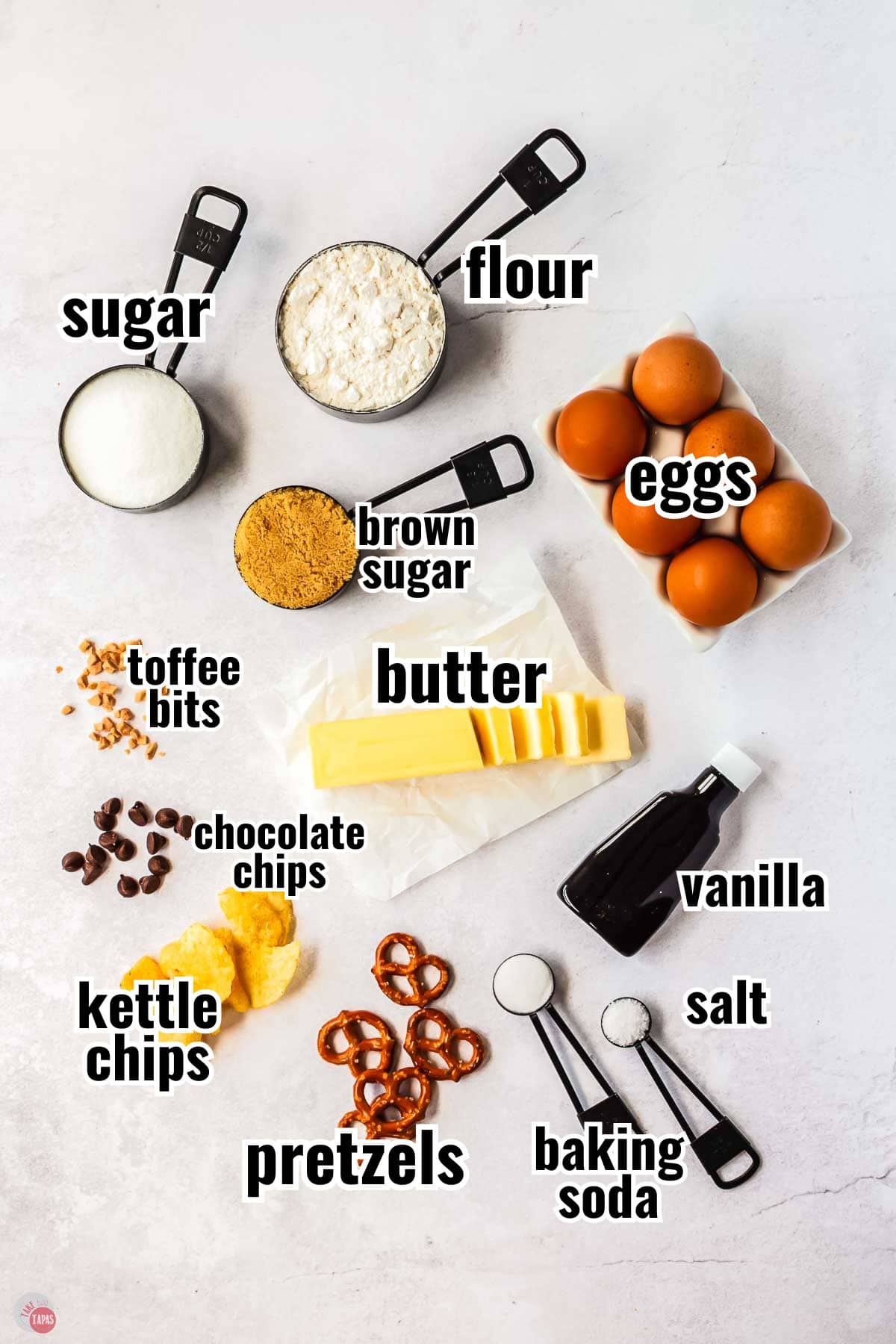 ingredients for a cookie recipe in individual bowls with text overlay labeling them