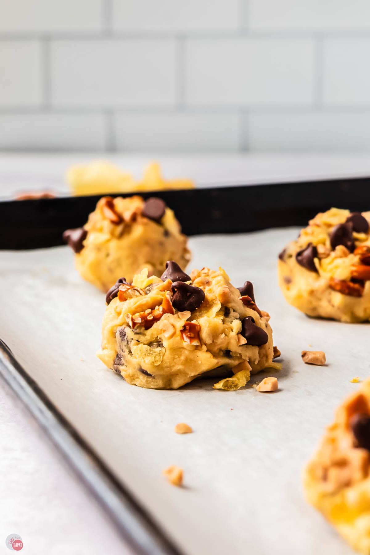 ball of cookie dough on a baking sheet with parchment paper
