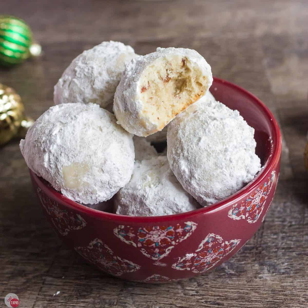 red bowl with a pile of snowball cookies
