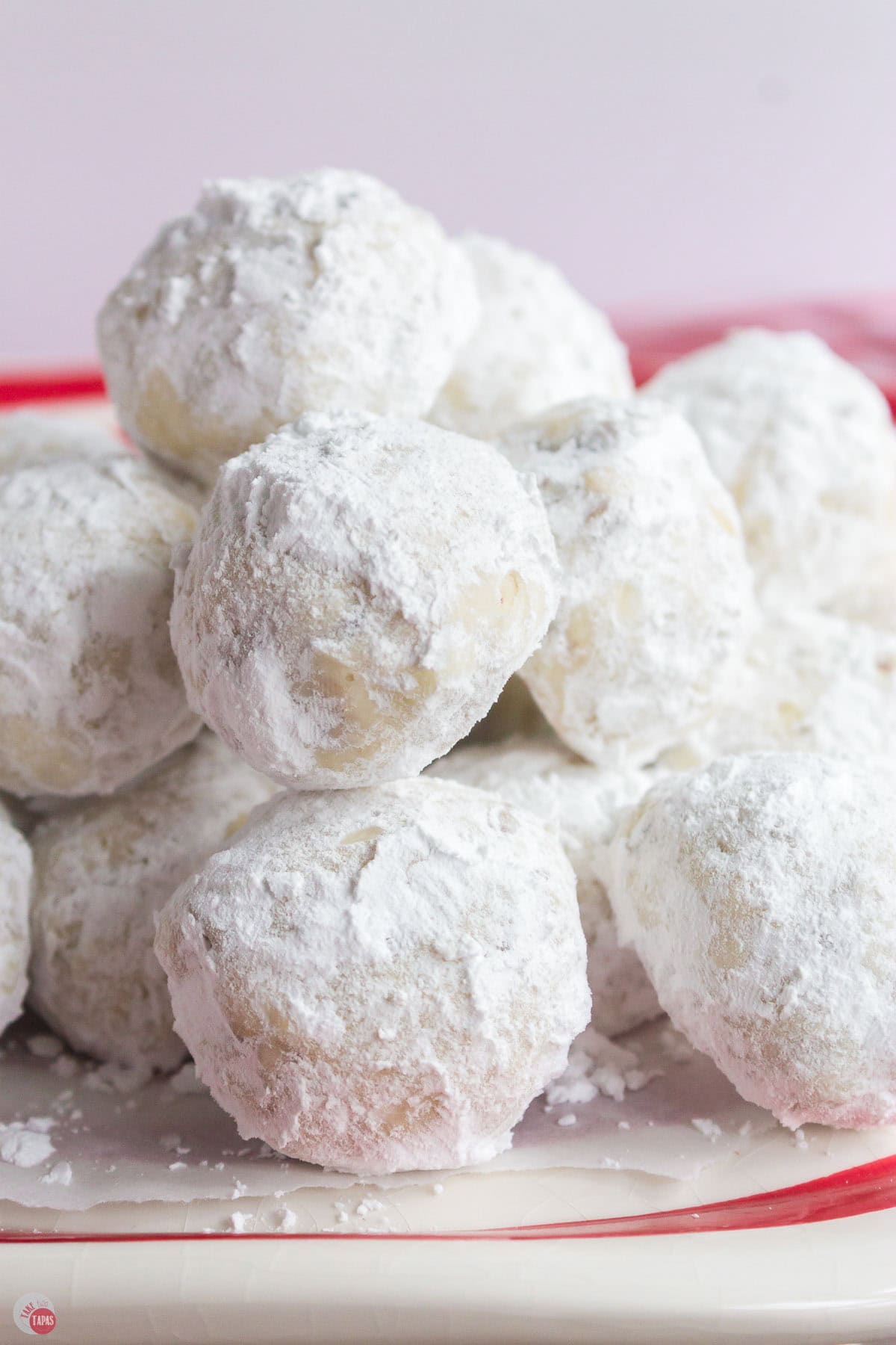 stack of white cookies coated in powdered sugar
