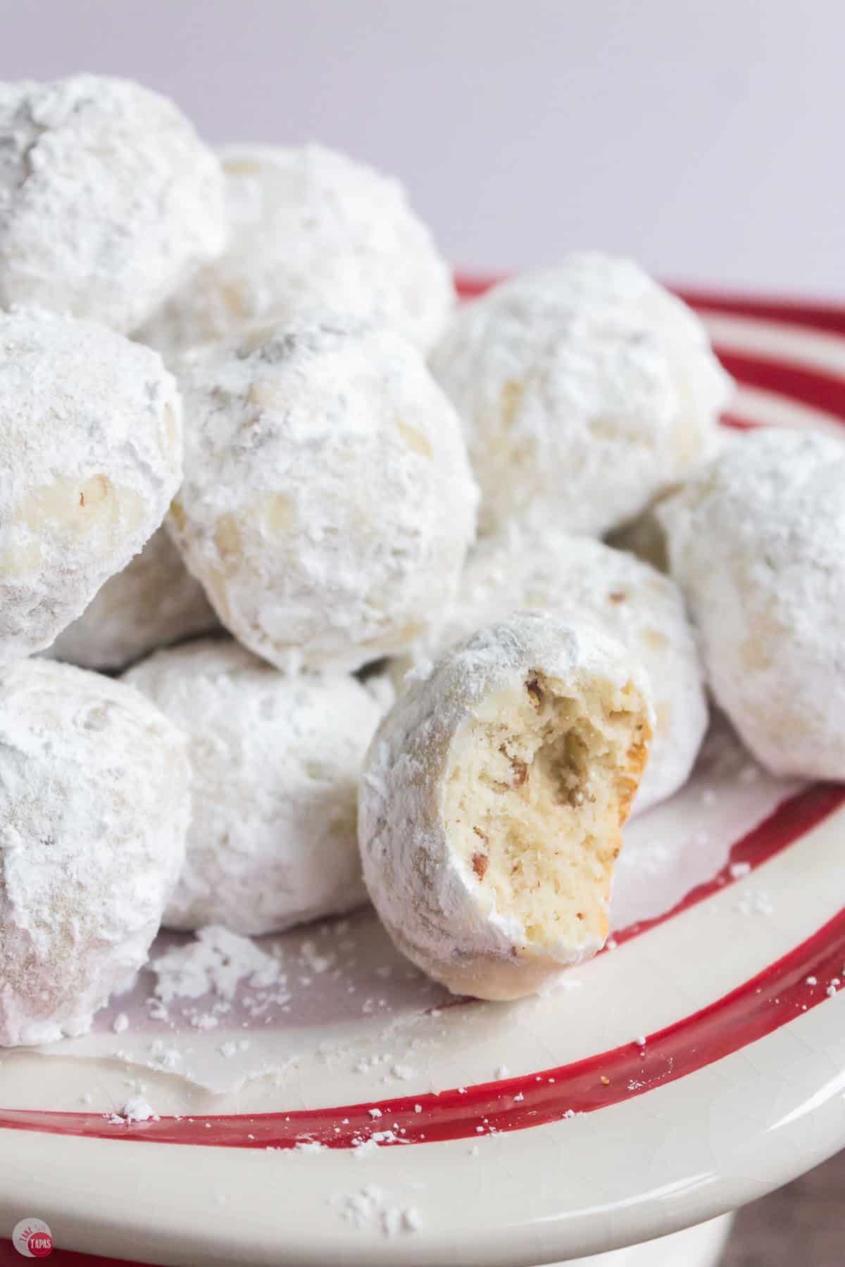 close up of stack of snowball cookies with one missing a bite