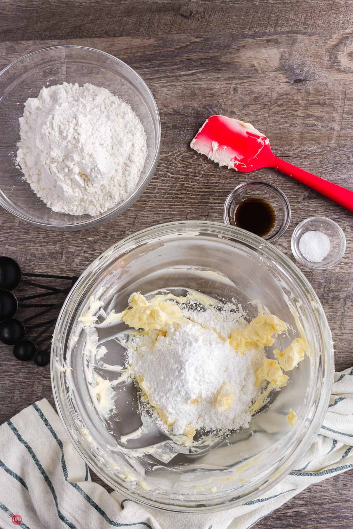 butter and sugar being mixed in a clear bowl