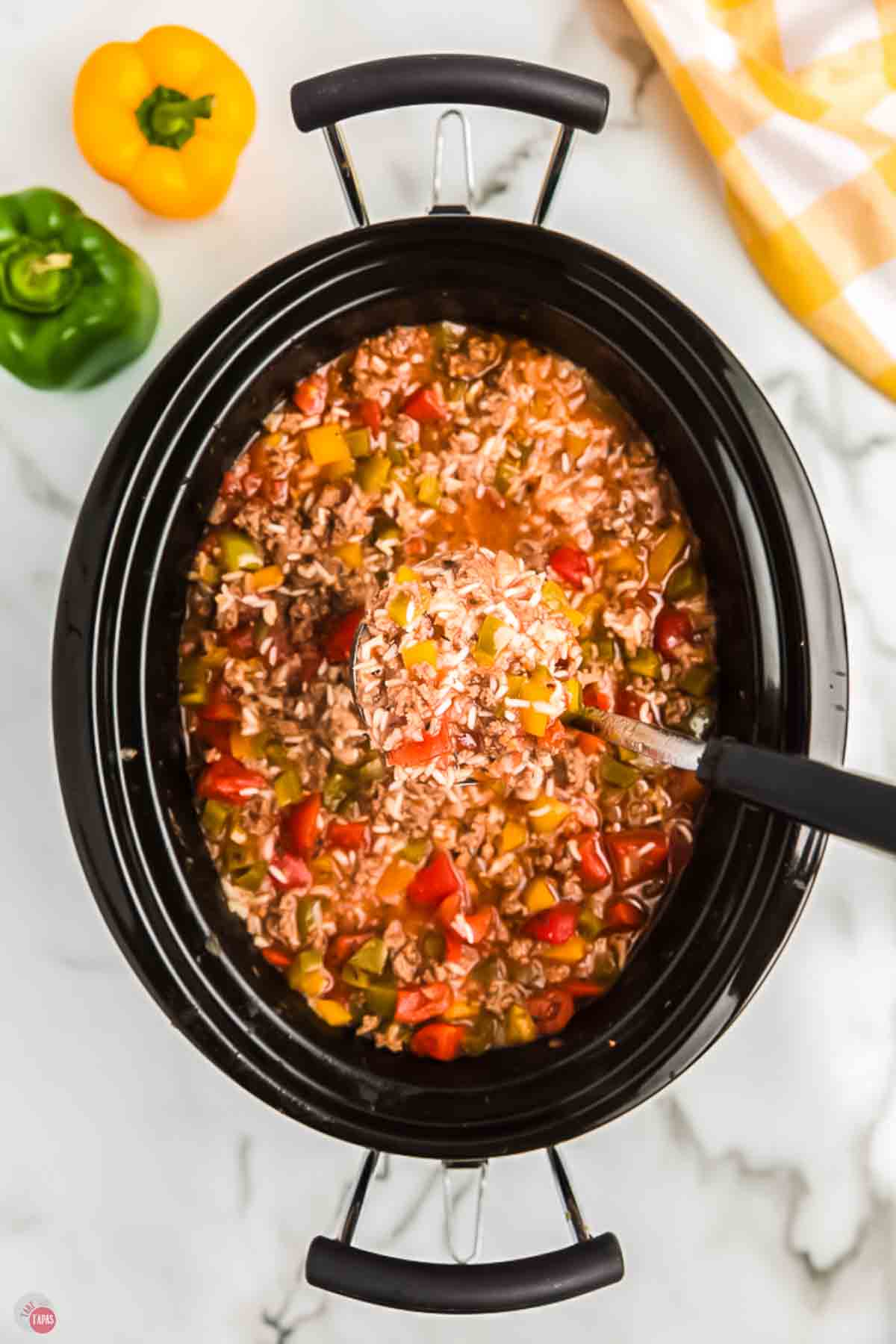black crockpot with pepper and rice soup