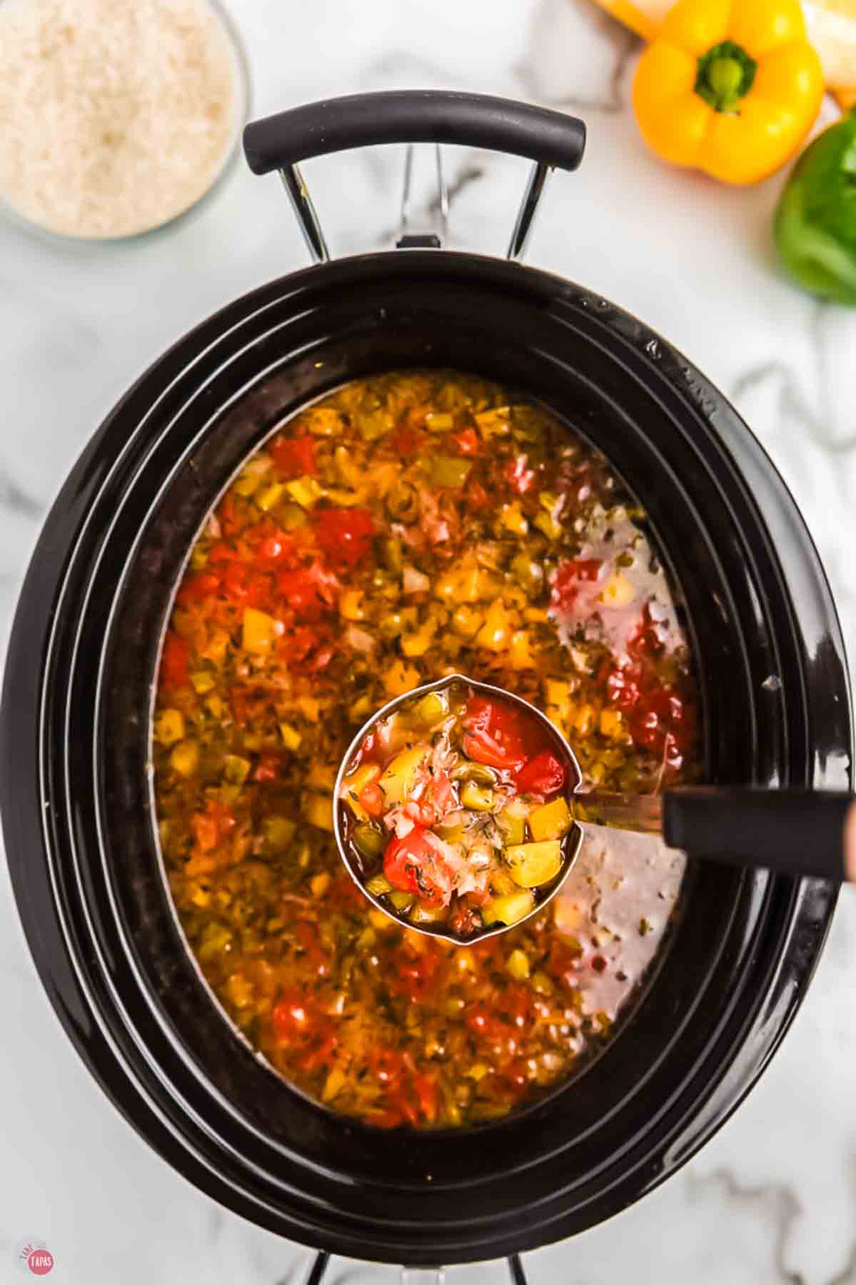 Pot of soup with a ladle scooping some out
