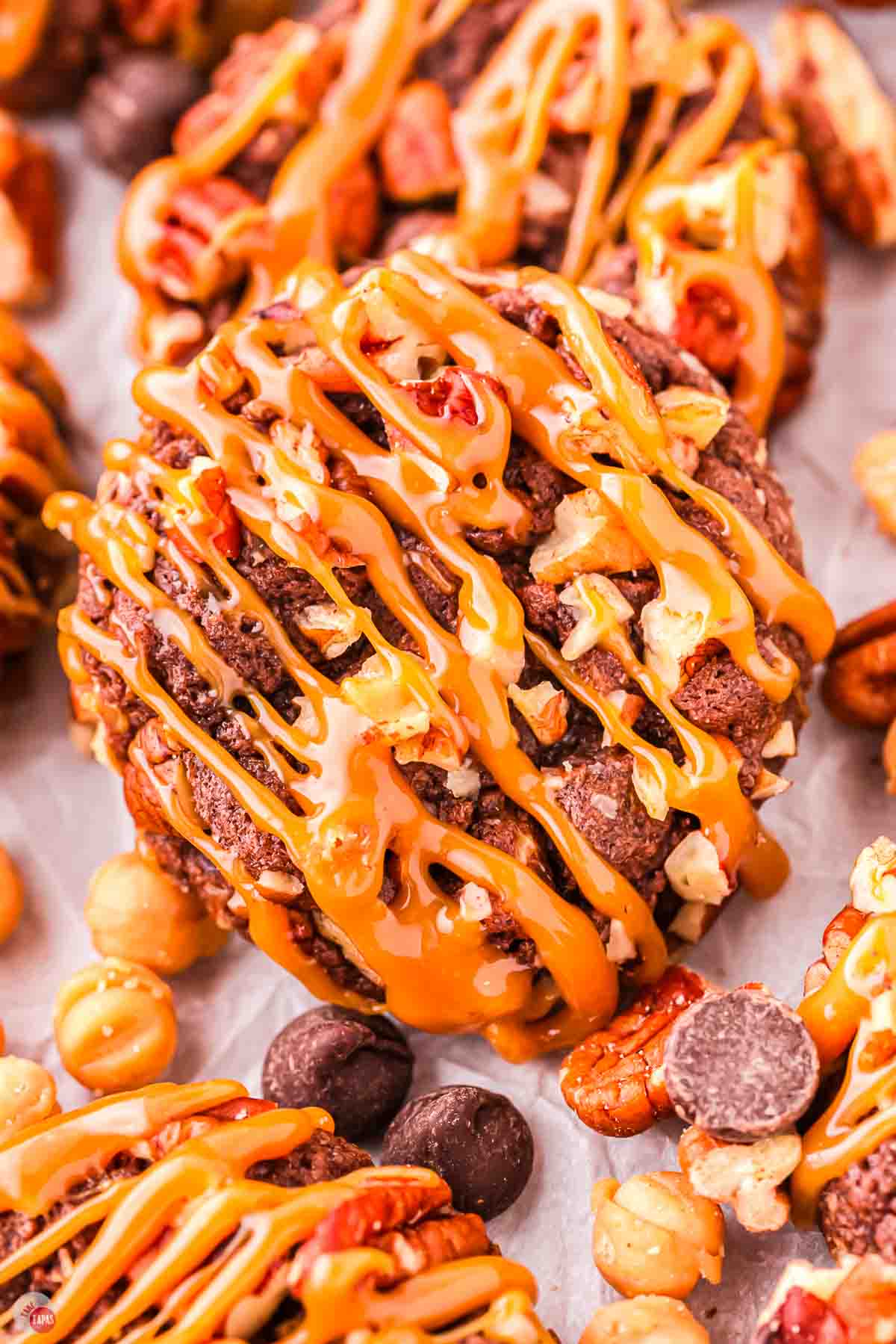 close up of turtle cookie on a piece of parchment paper