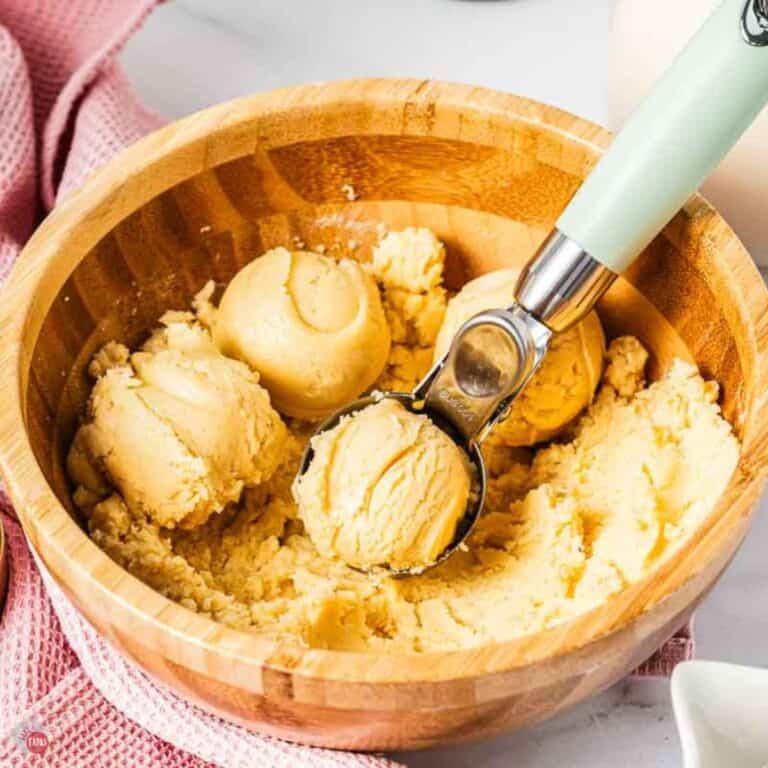 bowl of basic cookie dough with a scooper in it