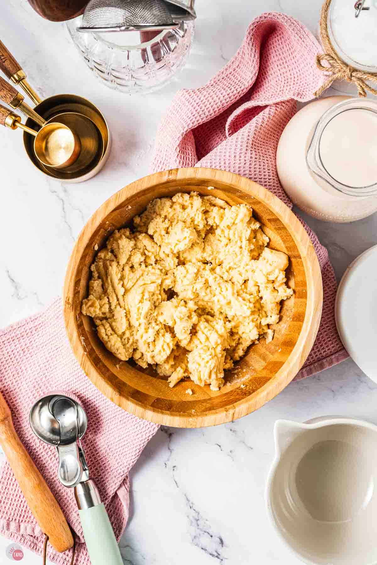 cookie dough in a wood bowl on to of a red napkin