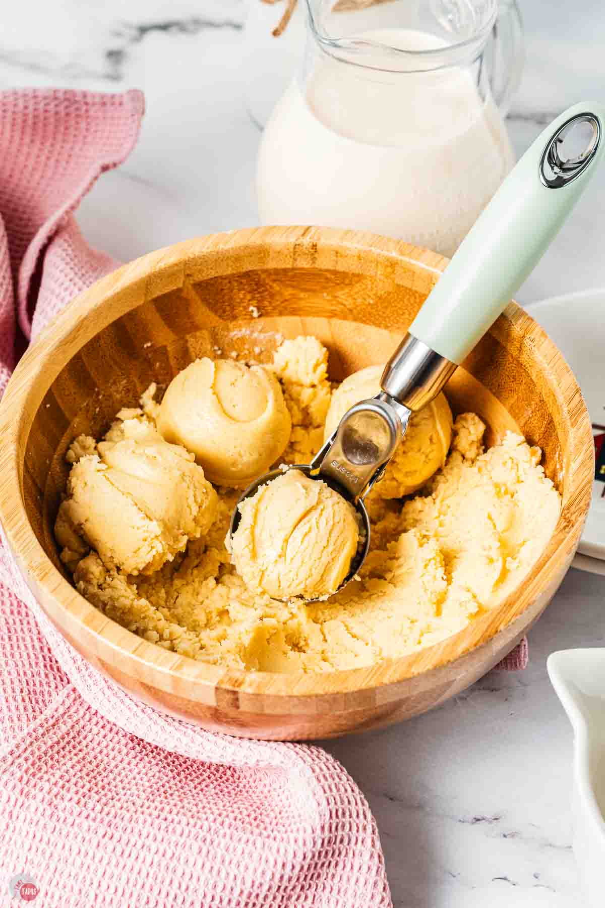 bowl of cookie dough with balls formed in the middle