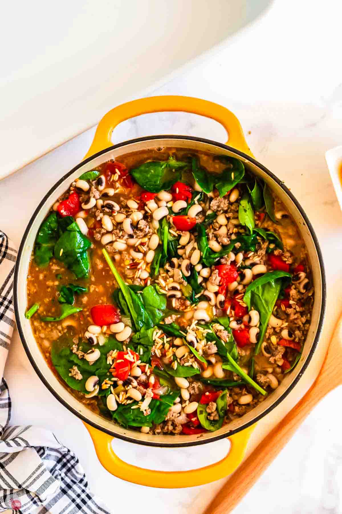 pot of black eyed peas with spinach and tomatoes