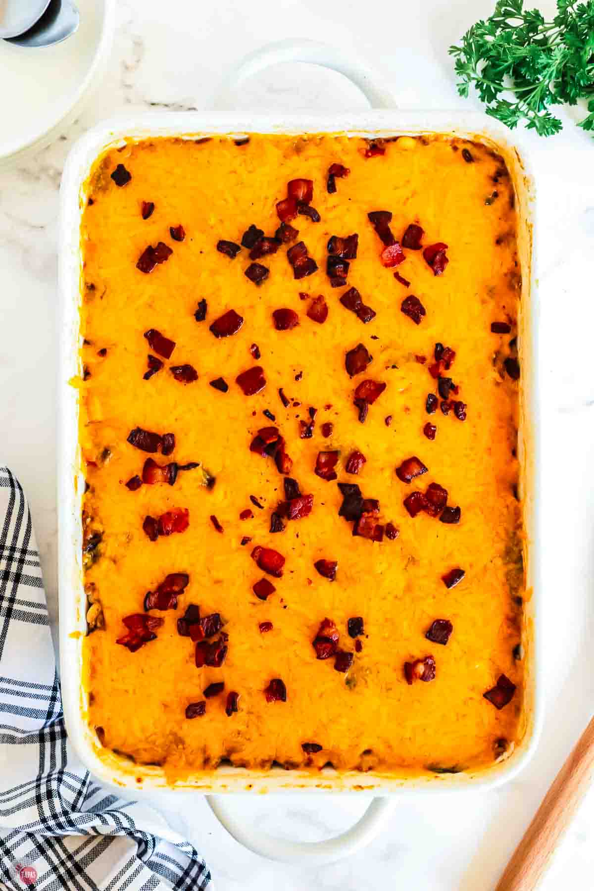 overhead picture of casserole topped with melted cheese and bacon