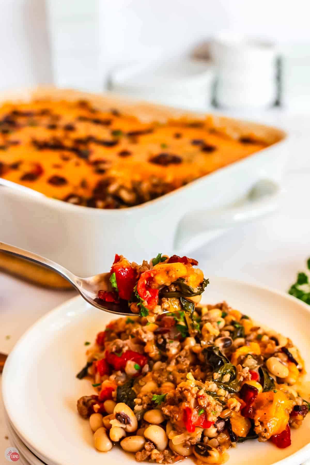 spoon of casserole over a dish