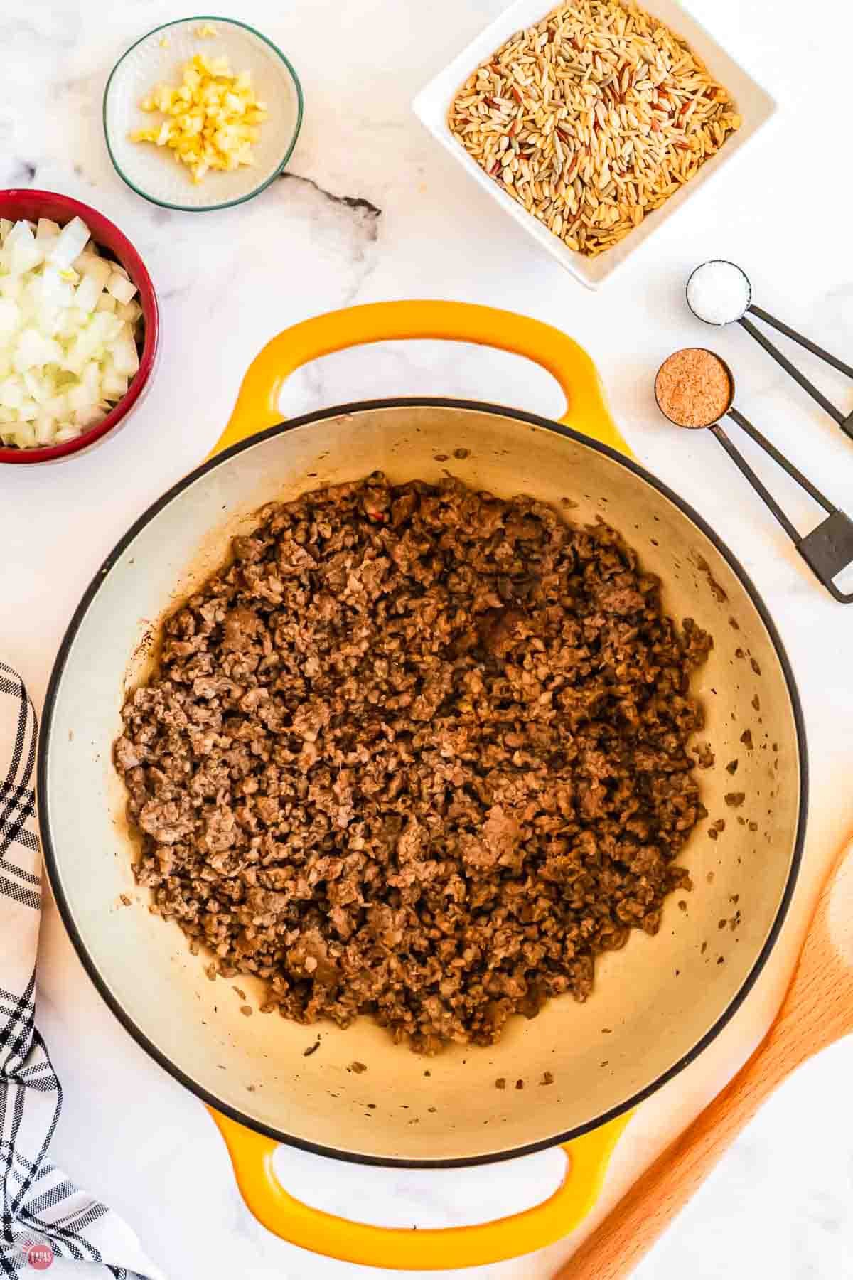 cooked ground sausage in a yellow pot