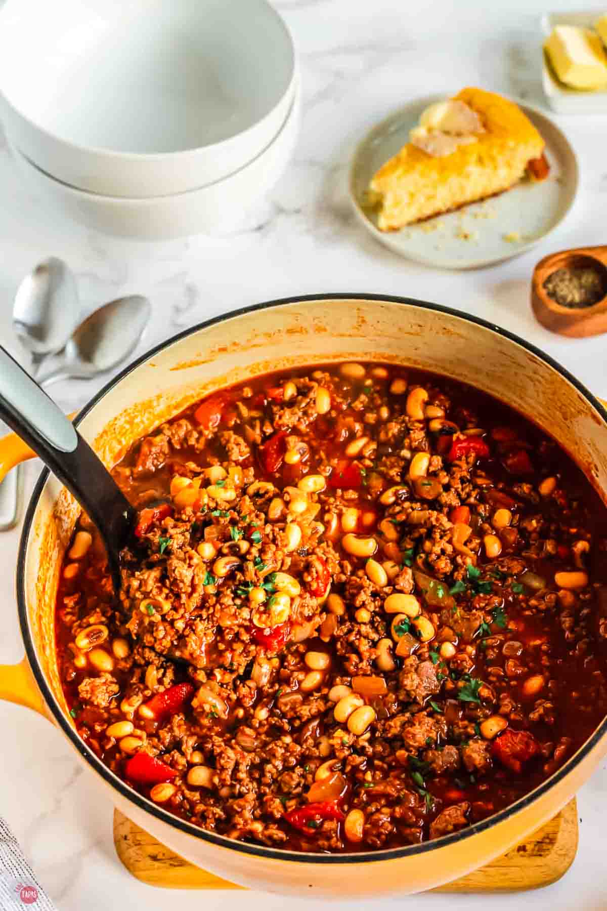 close up of yellow pot with a ladle getting soup out