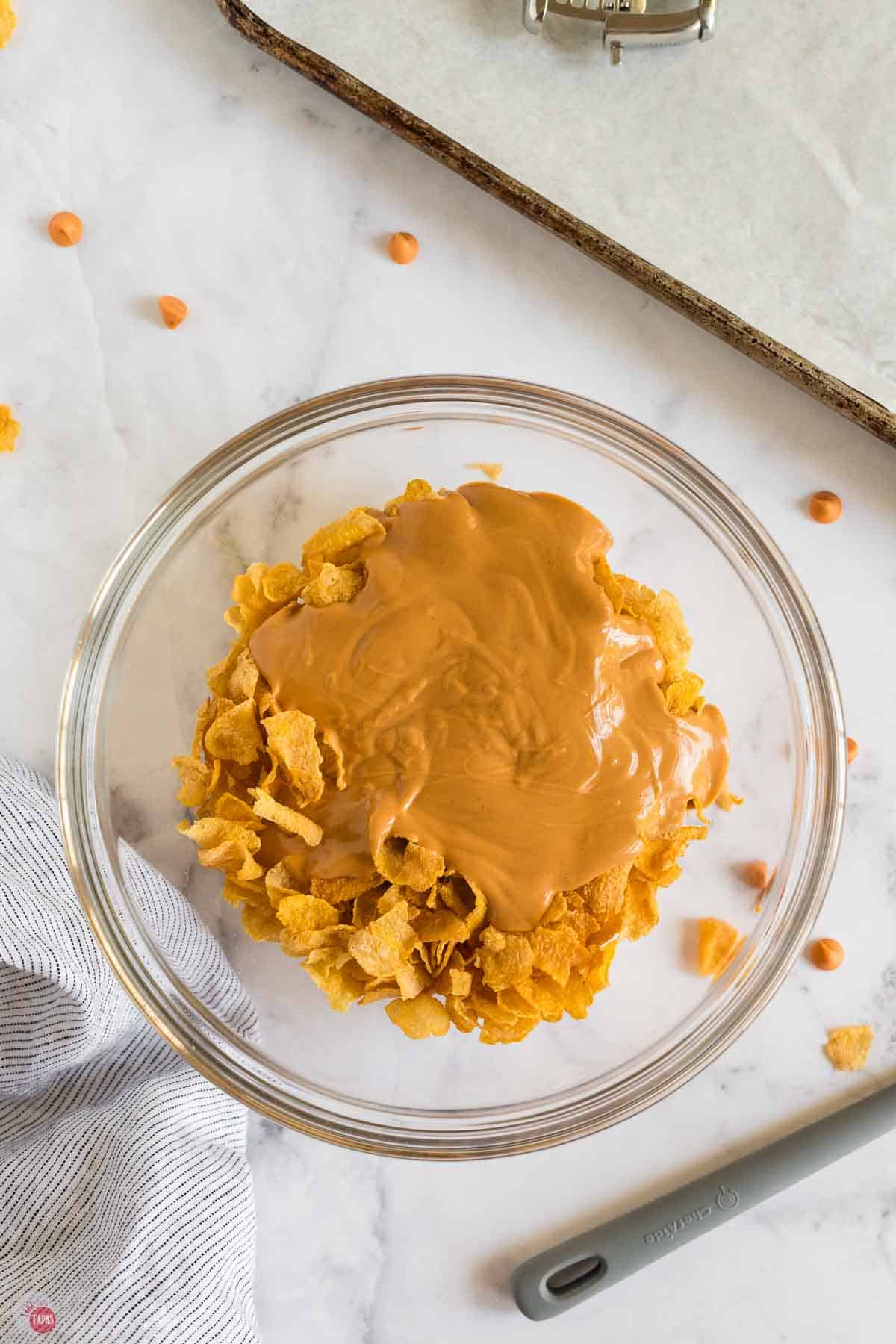 melted peanut butter on top of cereal in a clear bowl