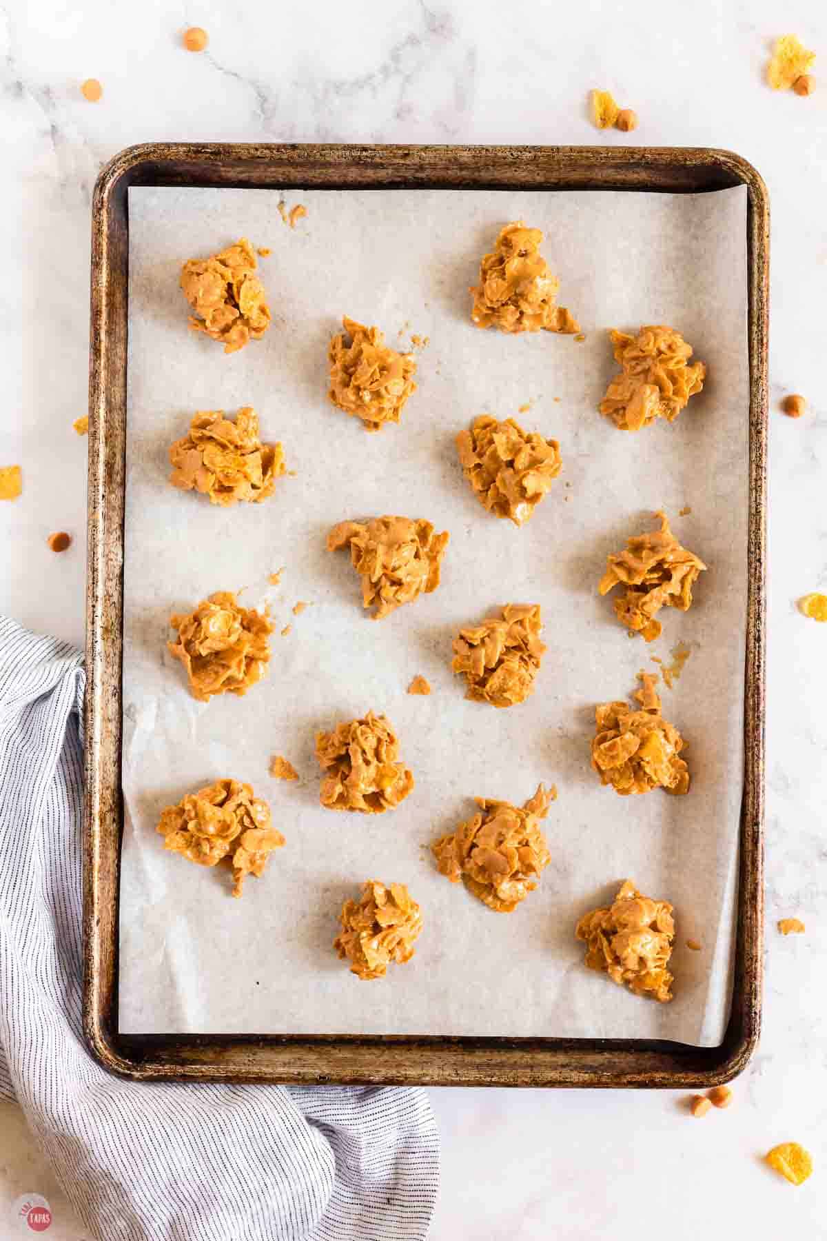 scoops of no bake cookies on a sheet of parchment paper
