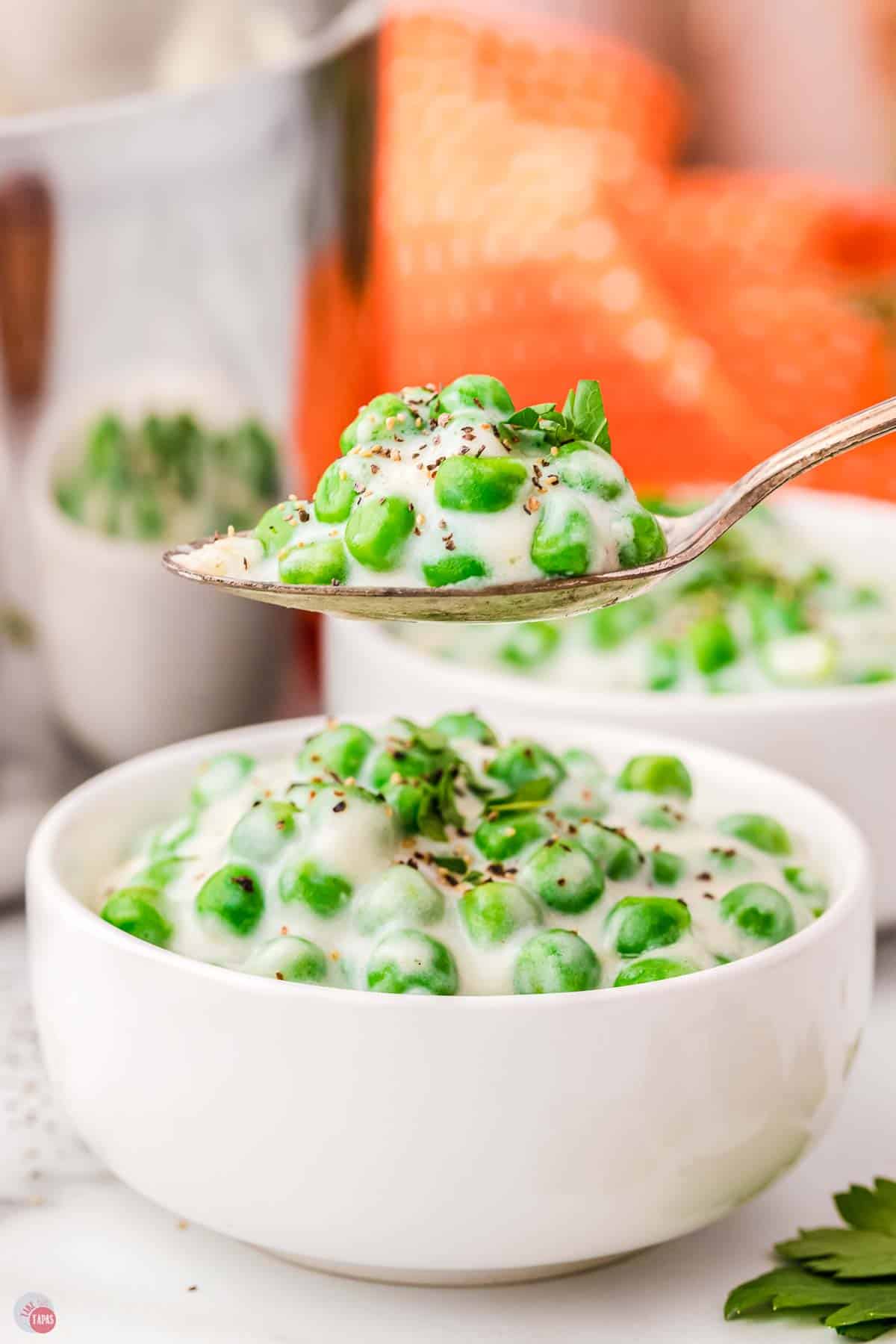 spoon of creamed peas over another bowl