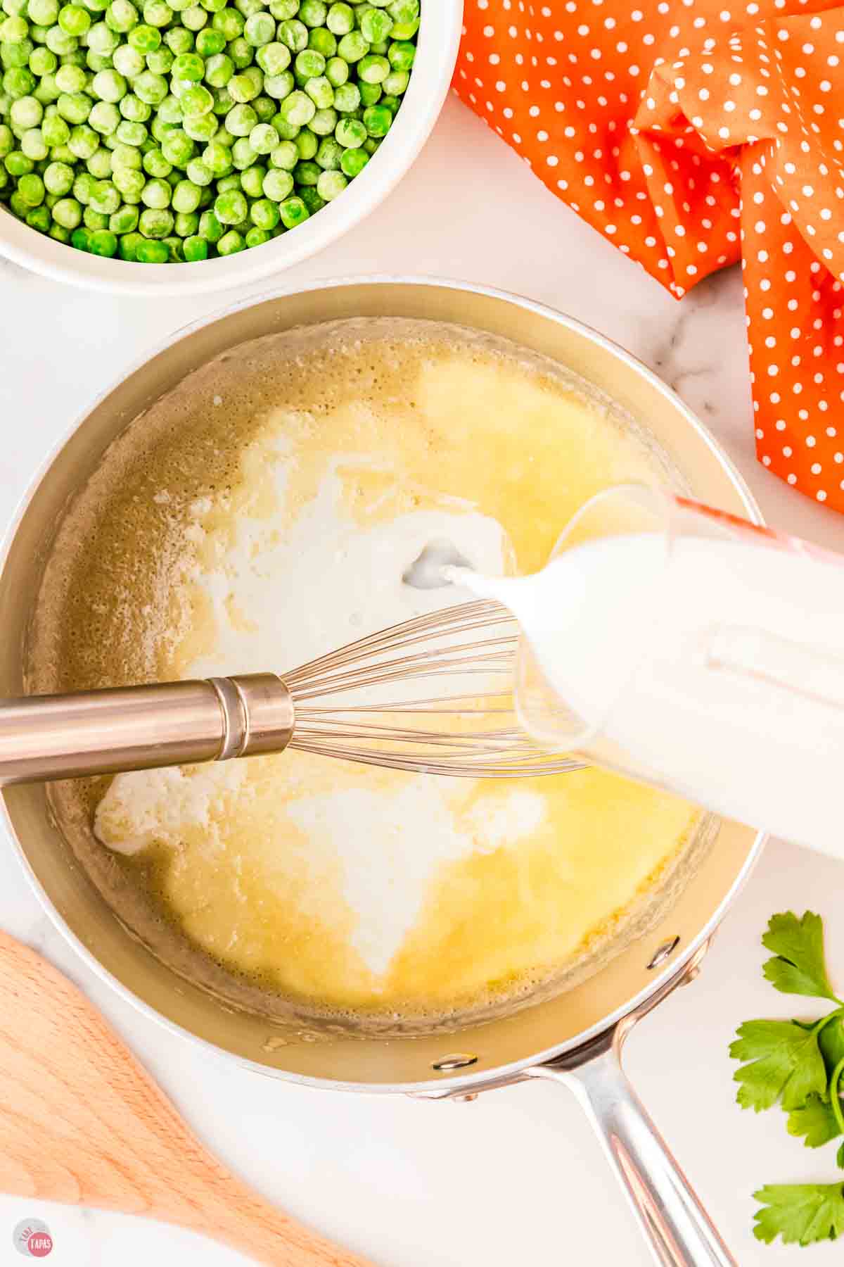 milk pouring in pan of melted butter