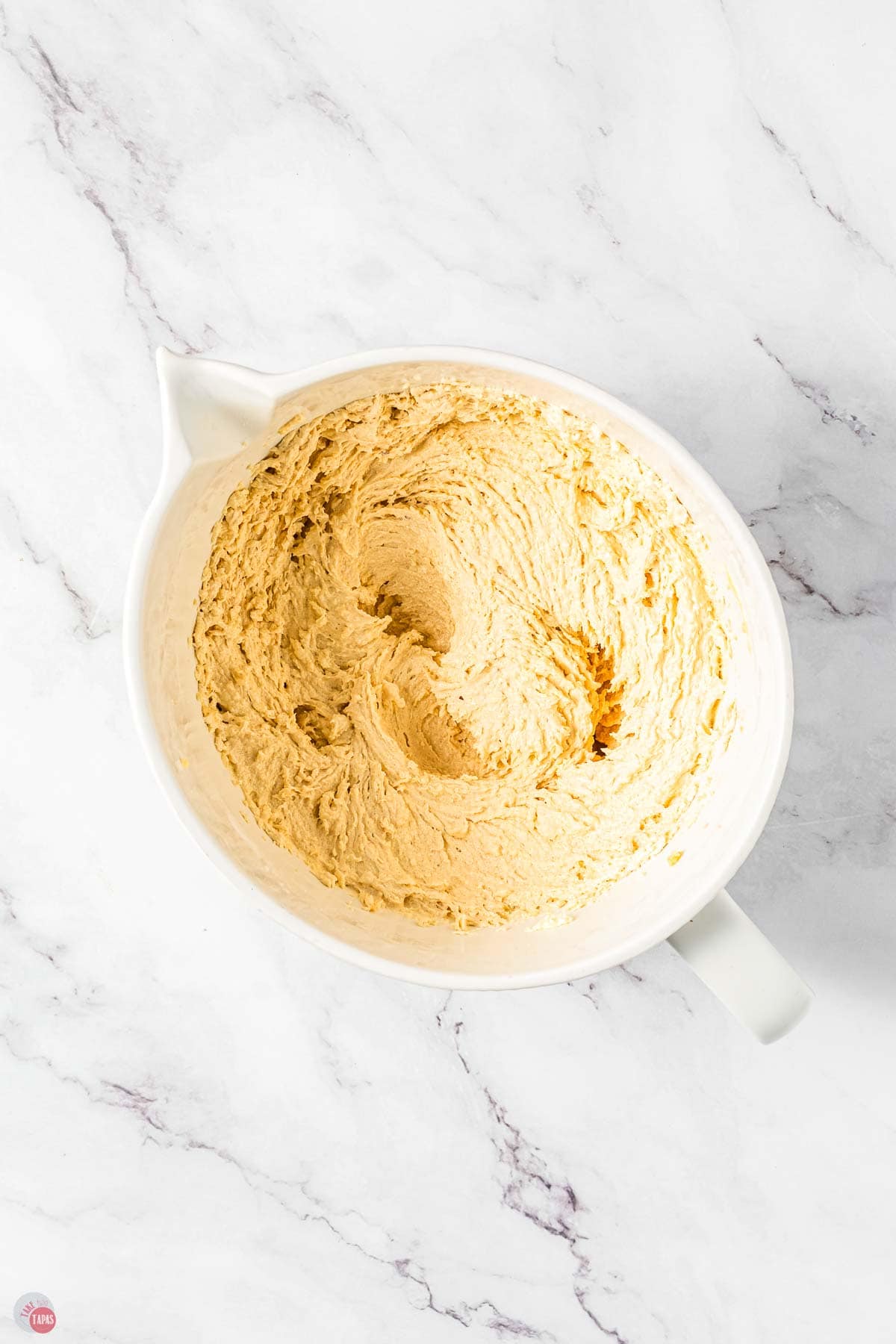 butter and sugar creamed in a white bowl