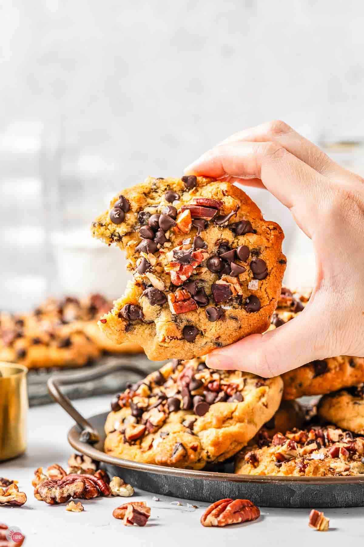 hand holding cookie with a bite missing