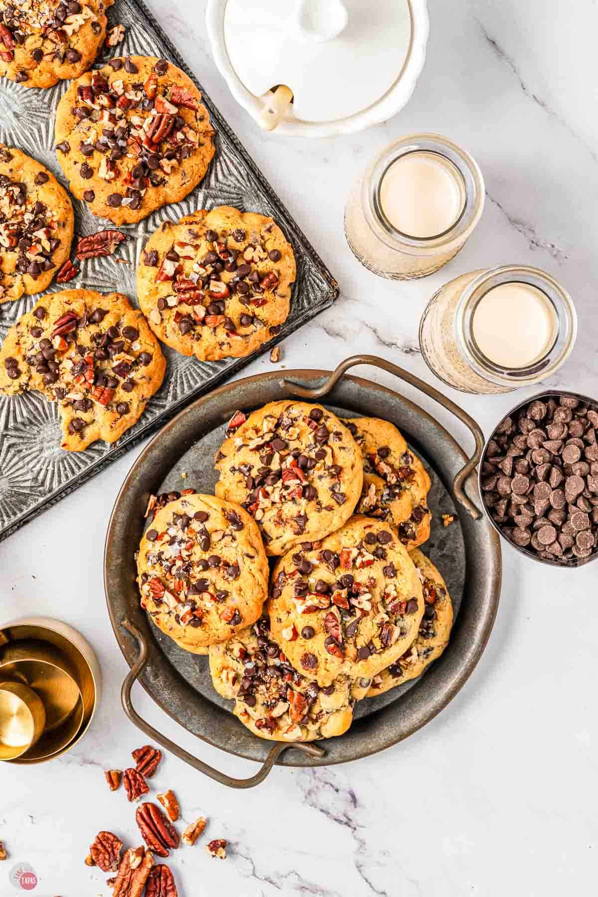 platters of cookies next to glasses of milk