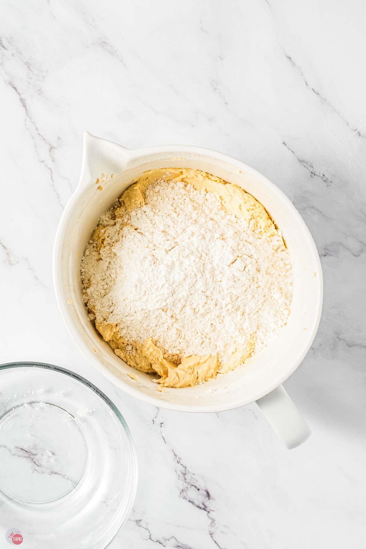 butter, sugar, and flour mixing in a white bowl