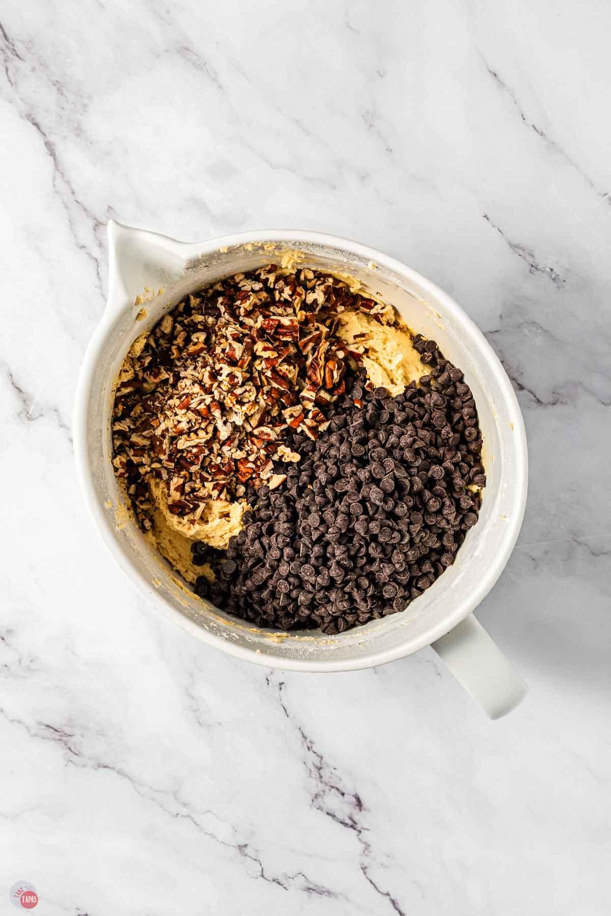 bowl with chopped pecans and chocolate chips