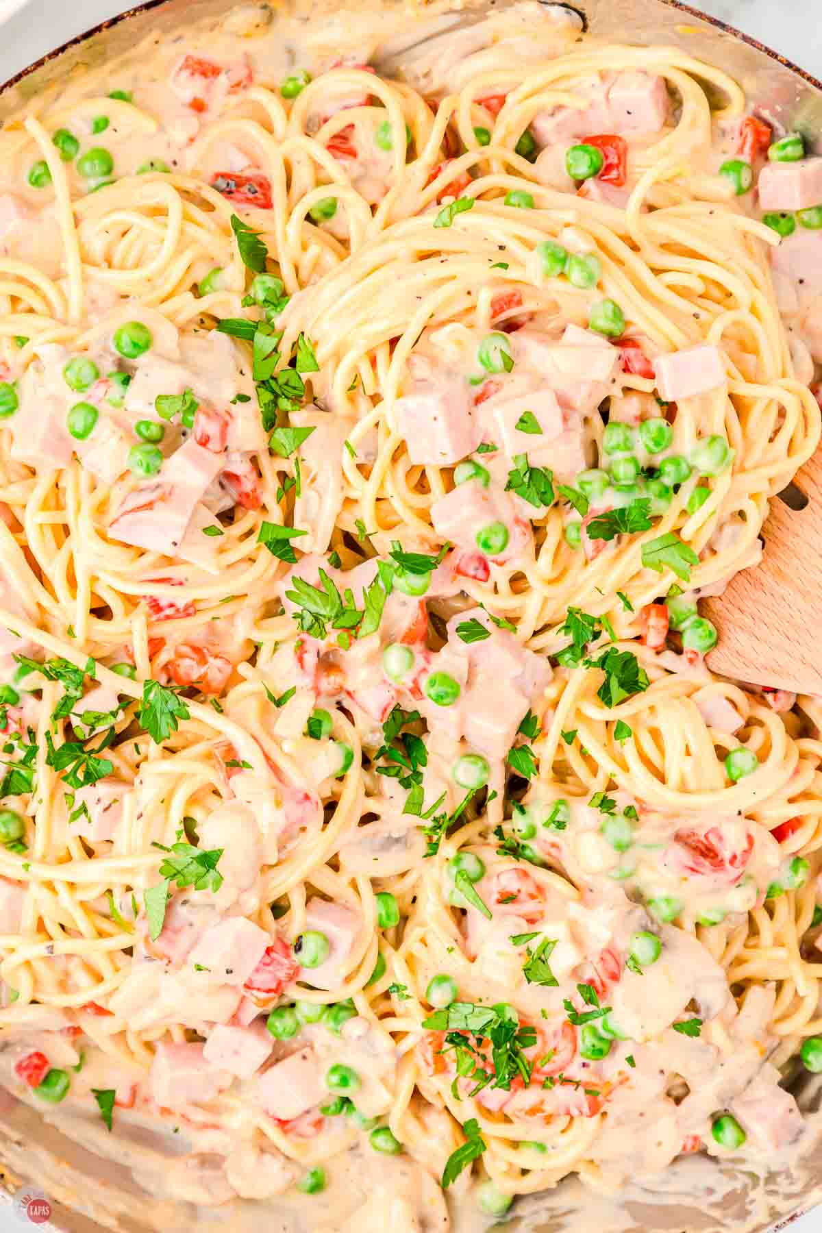 close up of ham tetrazzini with a wood spoon