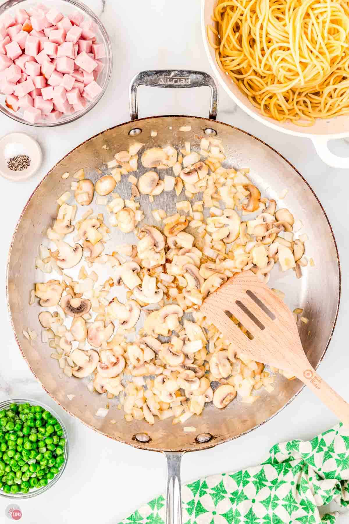 mushrooms cooking in a skiver skillet