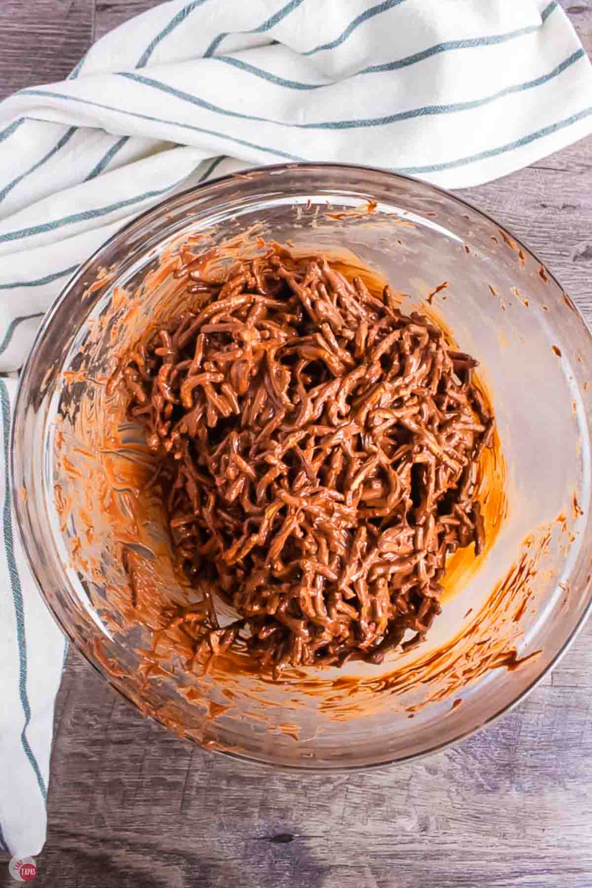 mixed chocolate and dry noodles in a clear bowl