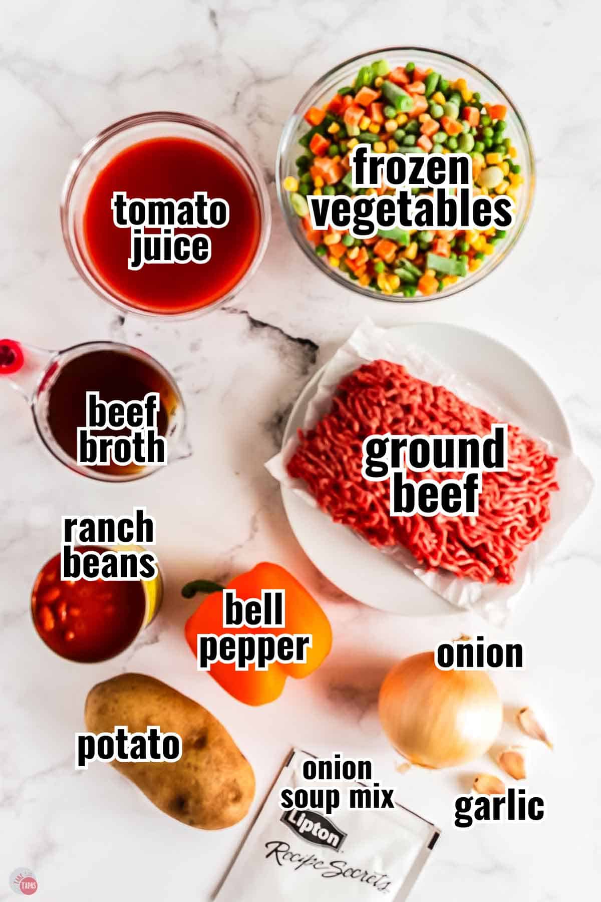 ingredients for soup on a marble counter with text overlay labeling them