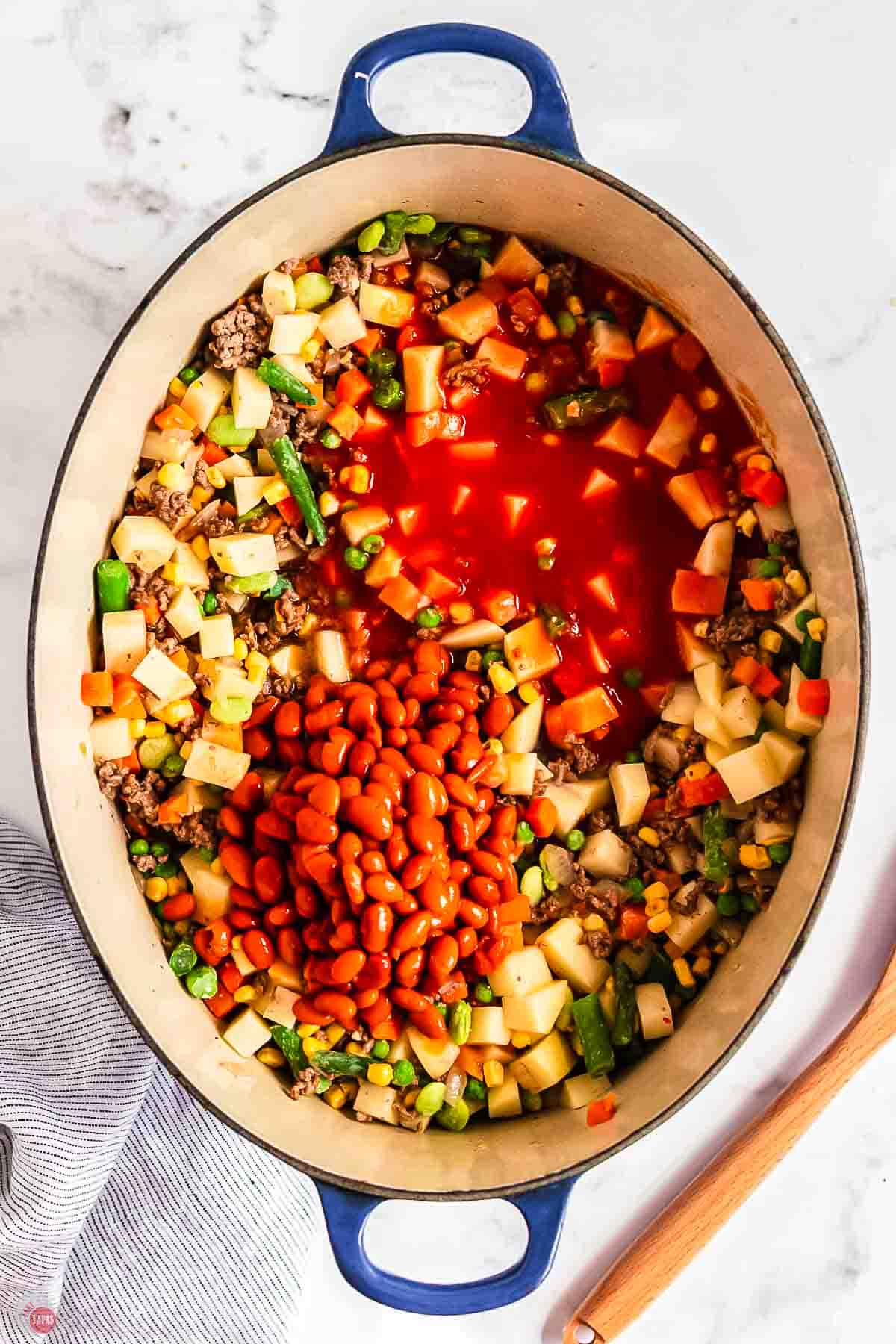 mixed vegetables in a large pot with beans and tomatoes