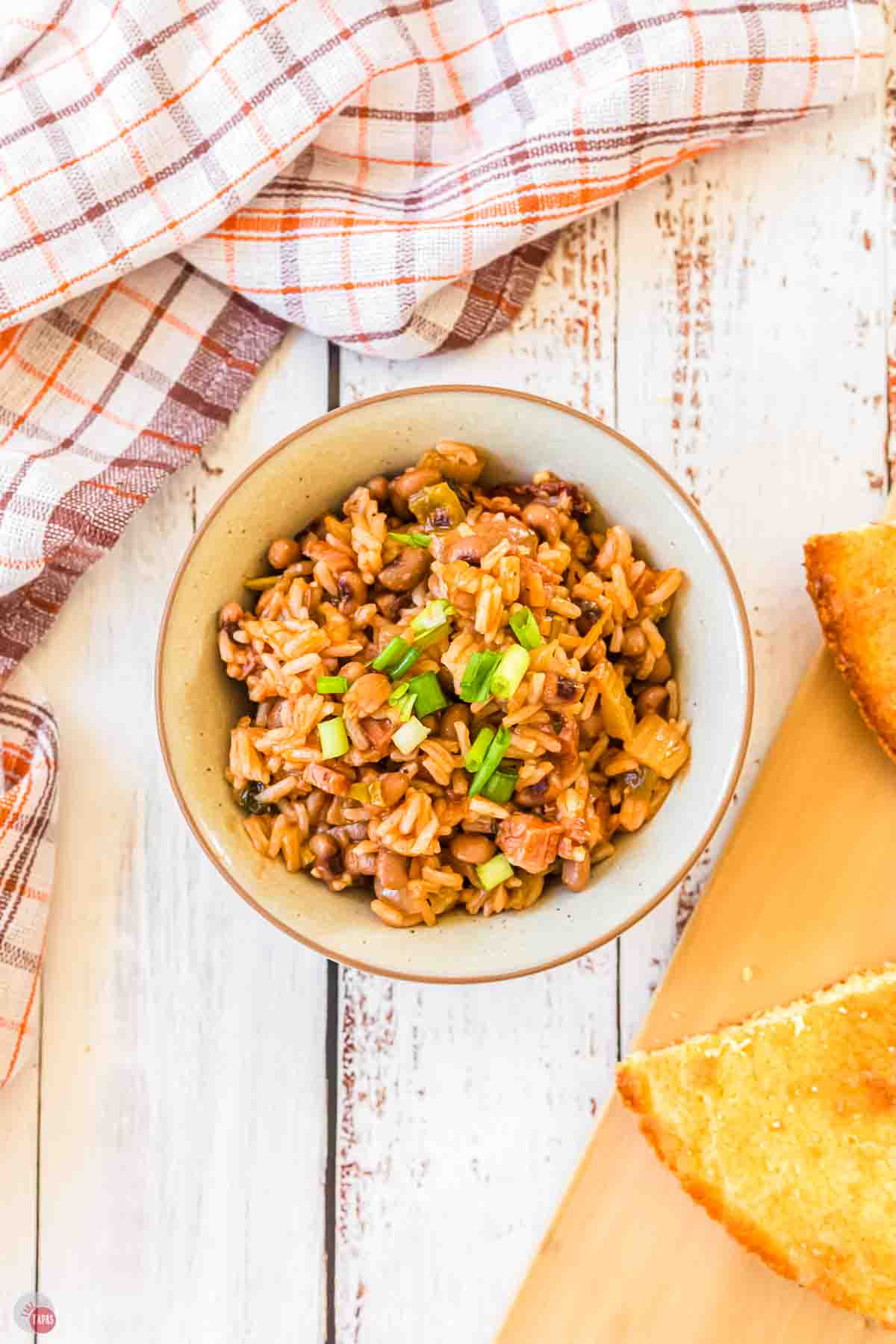 bowl of slow cooker hoppin john next to bread