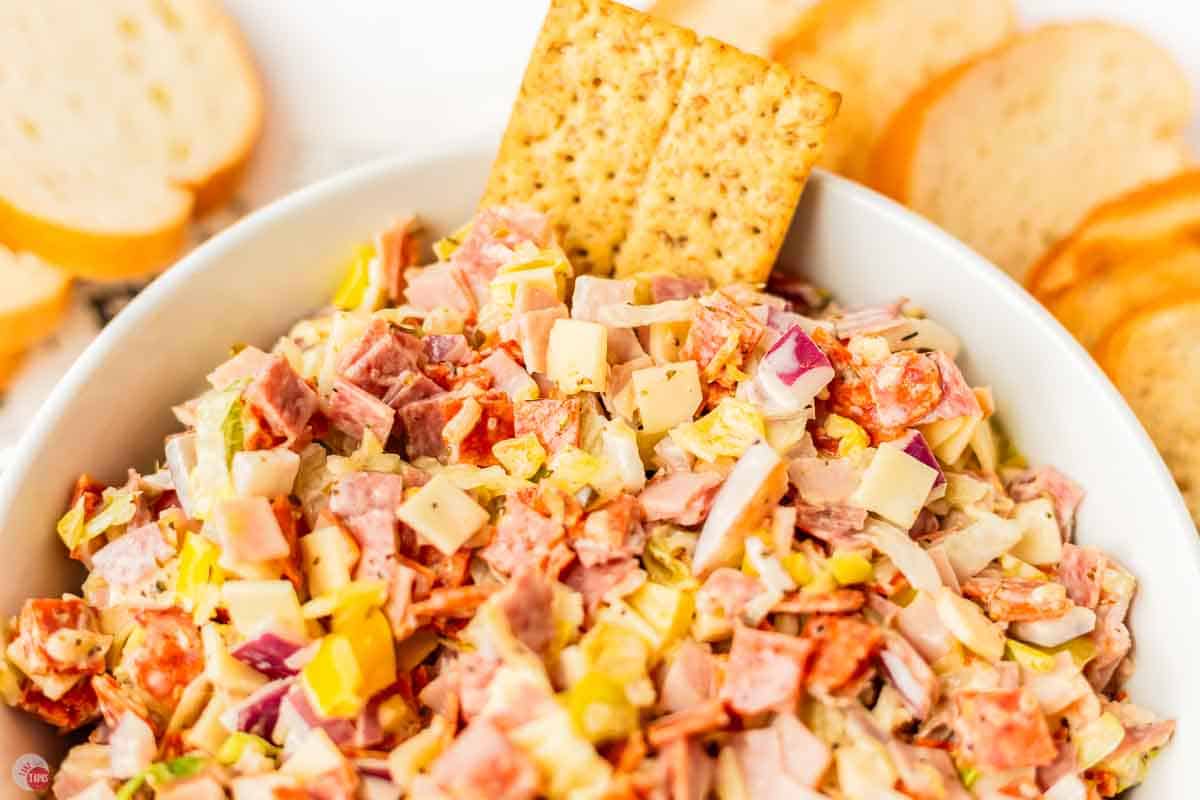 close up of cracker in chopped meat and vegetables