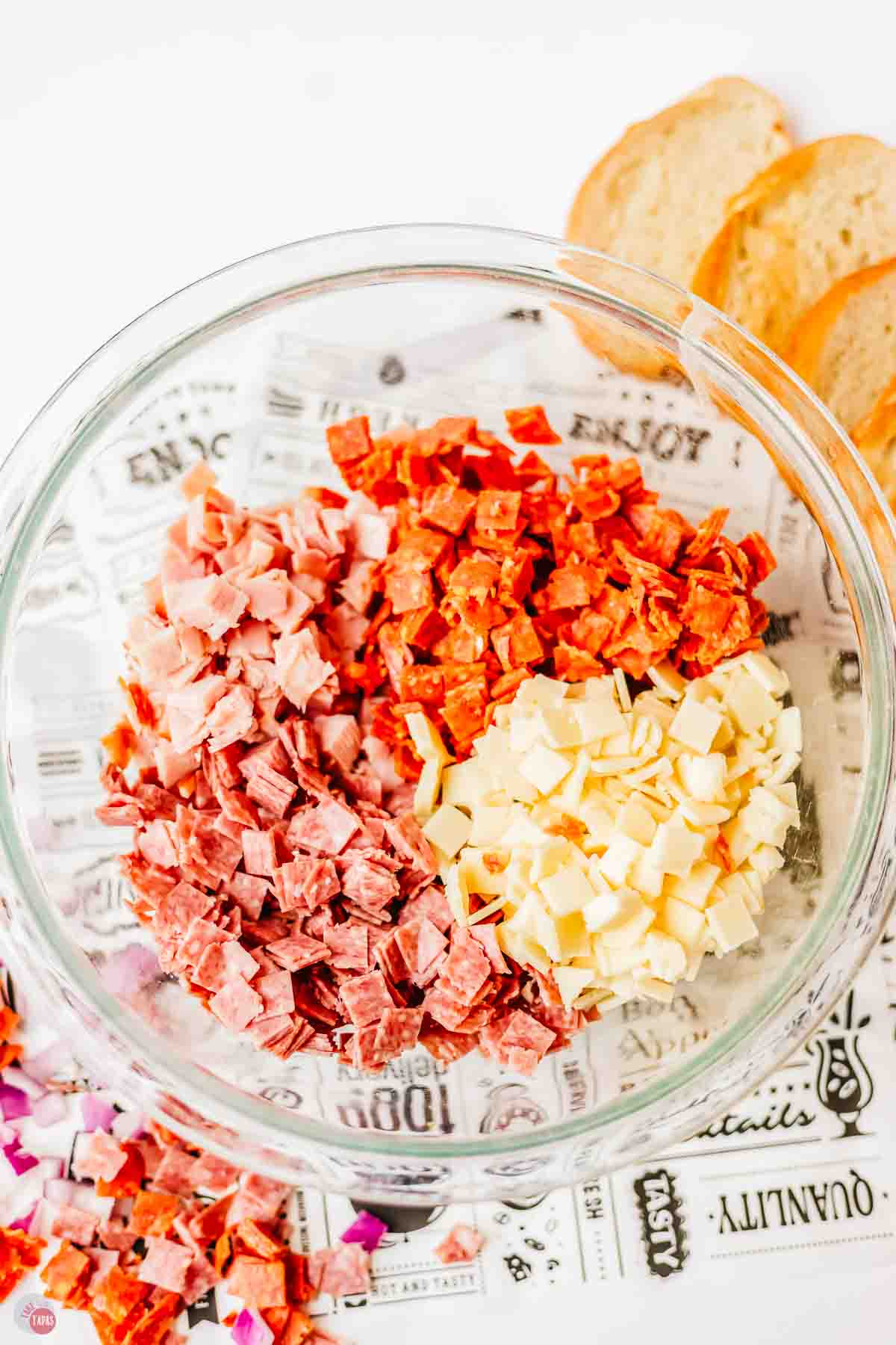 chopped meats and cheese in a clear bowl