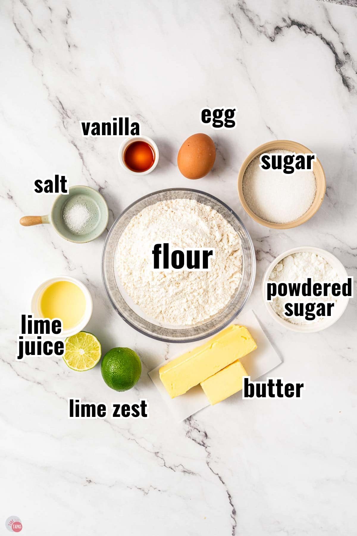 ingredients for a cookie recipe in individual bowls with text overlay labeling them