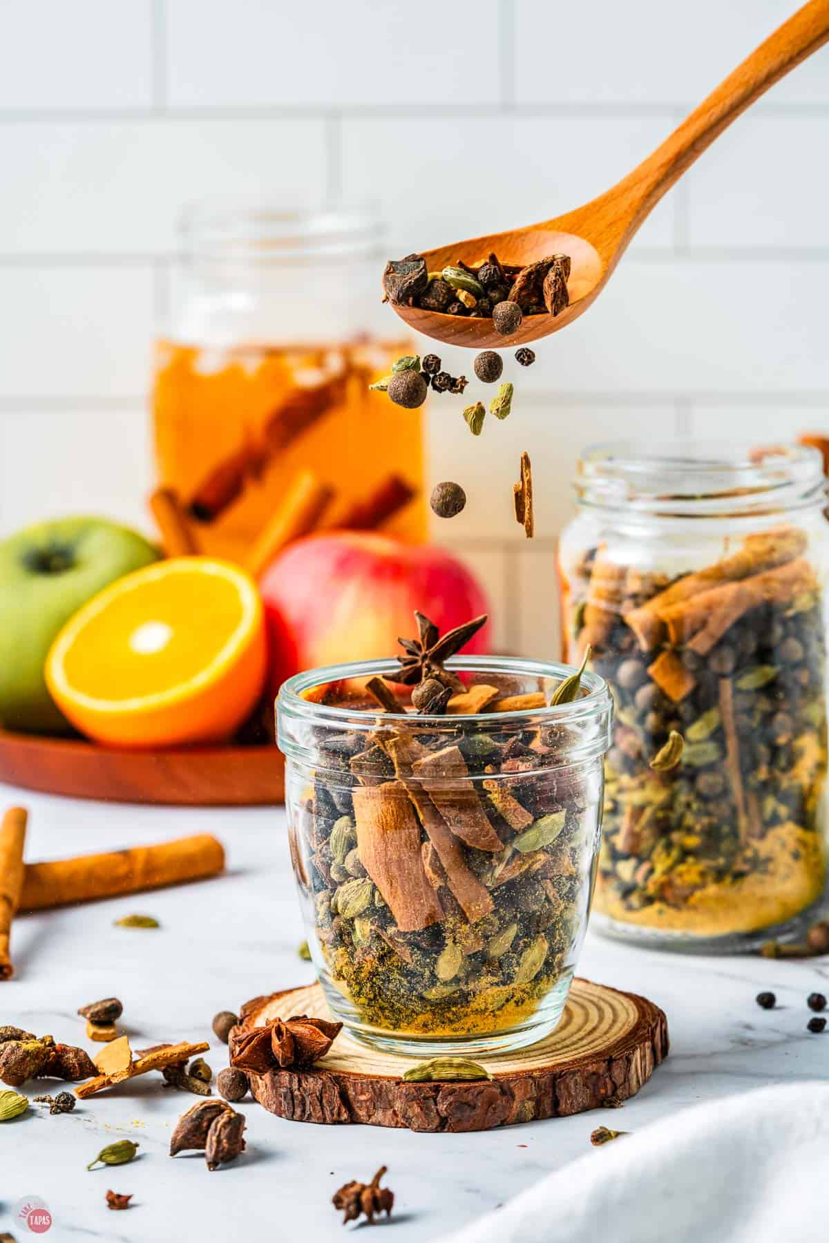 jar of spices with a spoon pouring some out